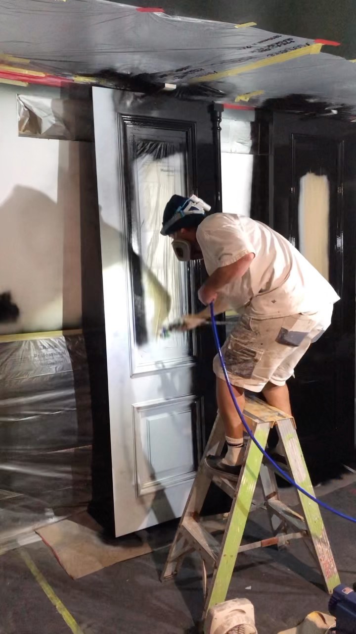 Nic in his whites, spraying a panelled door in black gloss